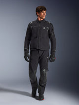 Male model wearing Alpinestars Andes Pro Drystar® XF Jacket, Black and Dark Gray adventure motorcycle jacket, paired with matching technical pants and gloves, featuring multiple pockets and 'Terra' branding on the chest.
