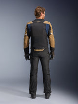 Alpinestars ST-2 Air Jacket in Deep Blue, Dark Khaki, and Black, rear view on model showing large mesh back panel and khaki sleeves with white stripes, paired with black technical motorcycle pants and gloves for adventure touring.
