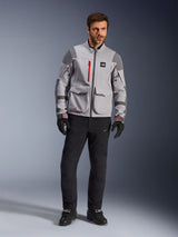 Alpinestars Maxdura Drystar®XF Laminated Armored Shell, Adventure Motorcycle Jacket, Mid Gray and Dark Gray with red accents, worn with black riding pants and gloves, front view highlighting technical construction and large cargo pockets.