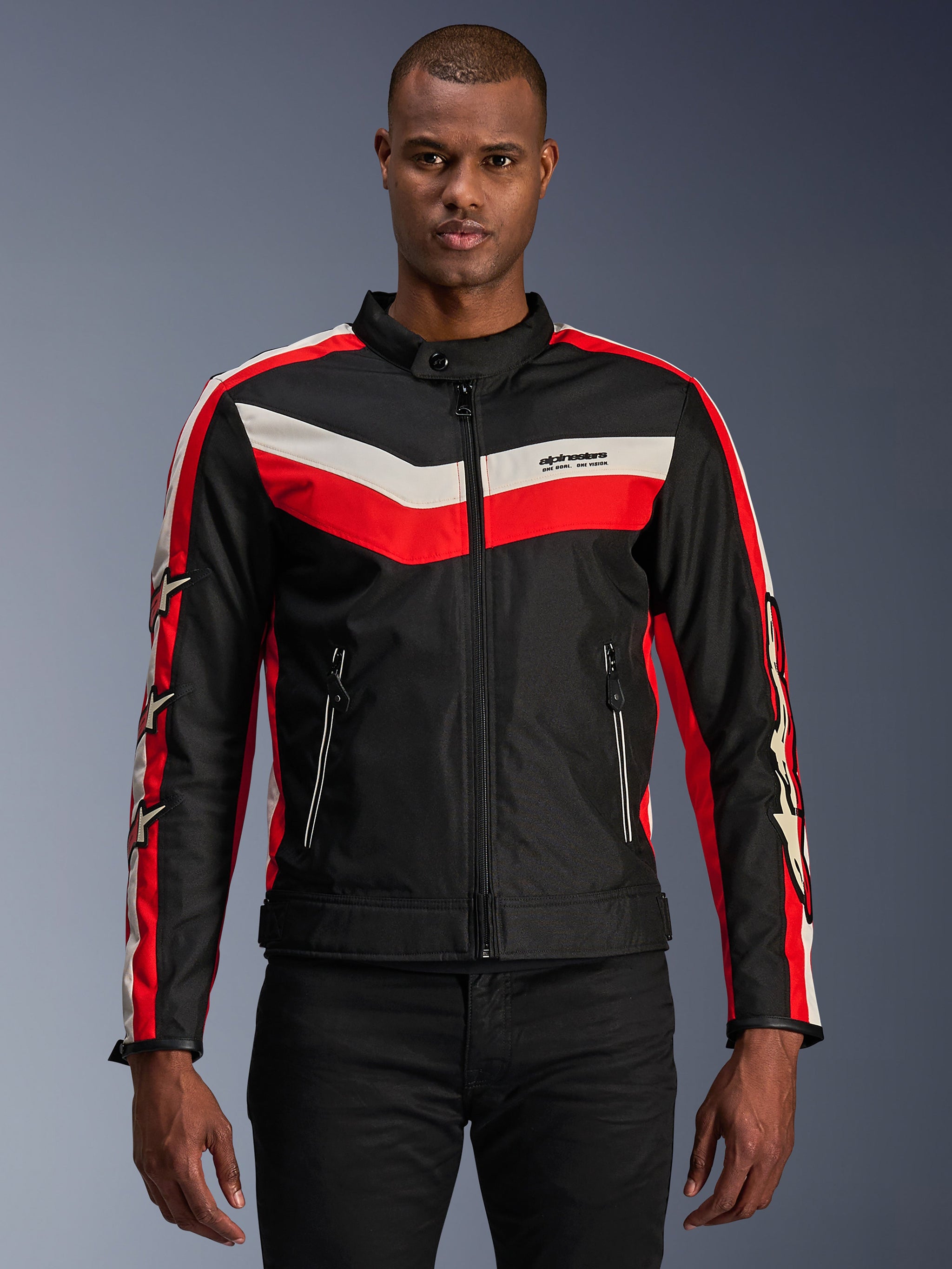 Alpinestars T-Dyno WR Jacket, Textile Motorcycle Jacket, Black with Bright Red and Ecru Chevron Stripes, vintage-inspired biker fit, high collar with button closure, zippered front pockets, star logos on sleeves, worn by model