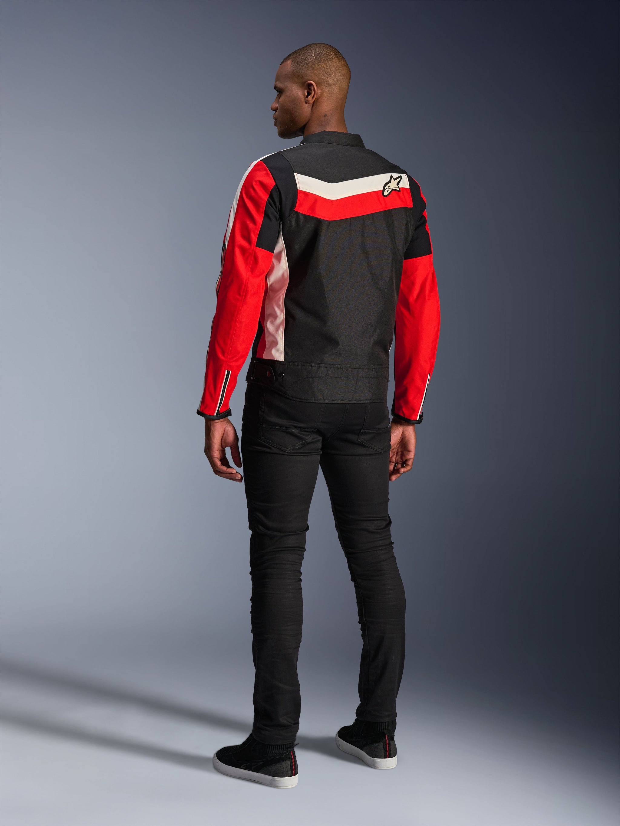 Alpinestars T-Dyno WR Jacket, Textile Motorcycle Jacket, Black Bright Red and Ecru, back view on model, vintage-inspired biker fit with heritage color panels and logo, modern urban road gear.