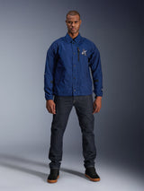 Alpinestars Revved WR Jacket, Navy Blue, coaches-style motorcycle jacket, worn by a man with dark denim jeans and black sneakers, featuring snap button closure and 3D Alpinestars logo, urban contemporary streetwear