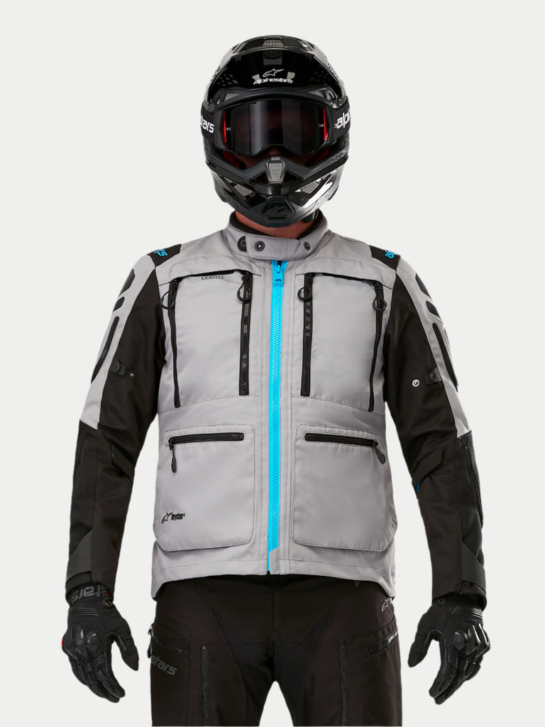 Model wearing the gray, black and blue Alpinestars Ardent 3-in-1 adventure motorcycle jacket, front view