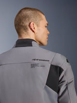 Alpinestars SMX Waterproof Jacket in Dark Gray Black, close-up of the back and shoulder area showing Alpinestars branding and DFS lite shoulder protection, worn by a male model