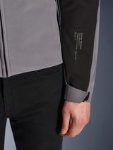 Alpinestars SMX Waterproof Jacket, Dark Gray and Black, close-up of sleeve featuring white printed text with brand heritage details, adjustable Velcro cuff, sporty textile design for all-weather motorcycle riding