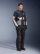 Male model wearing the Alpinestars Andes Air Drystar® Jacket in Deep Blue Black Ice Gray, paired with black motorcycle pants, gloves, and boots, featuring large mesh panels for ventilation, light gray pockets, and red accents, designed for adventure touring.