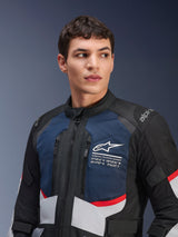 Alpinestars Andes Air Drystar® Jacket, Motorcycle Jacket, Deep Blue Black and Ice Gray with red accents, worn by male model, featuring ventilated mesh chest panels, white star logo with exploration coordinates, and road-ready adventure design