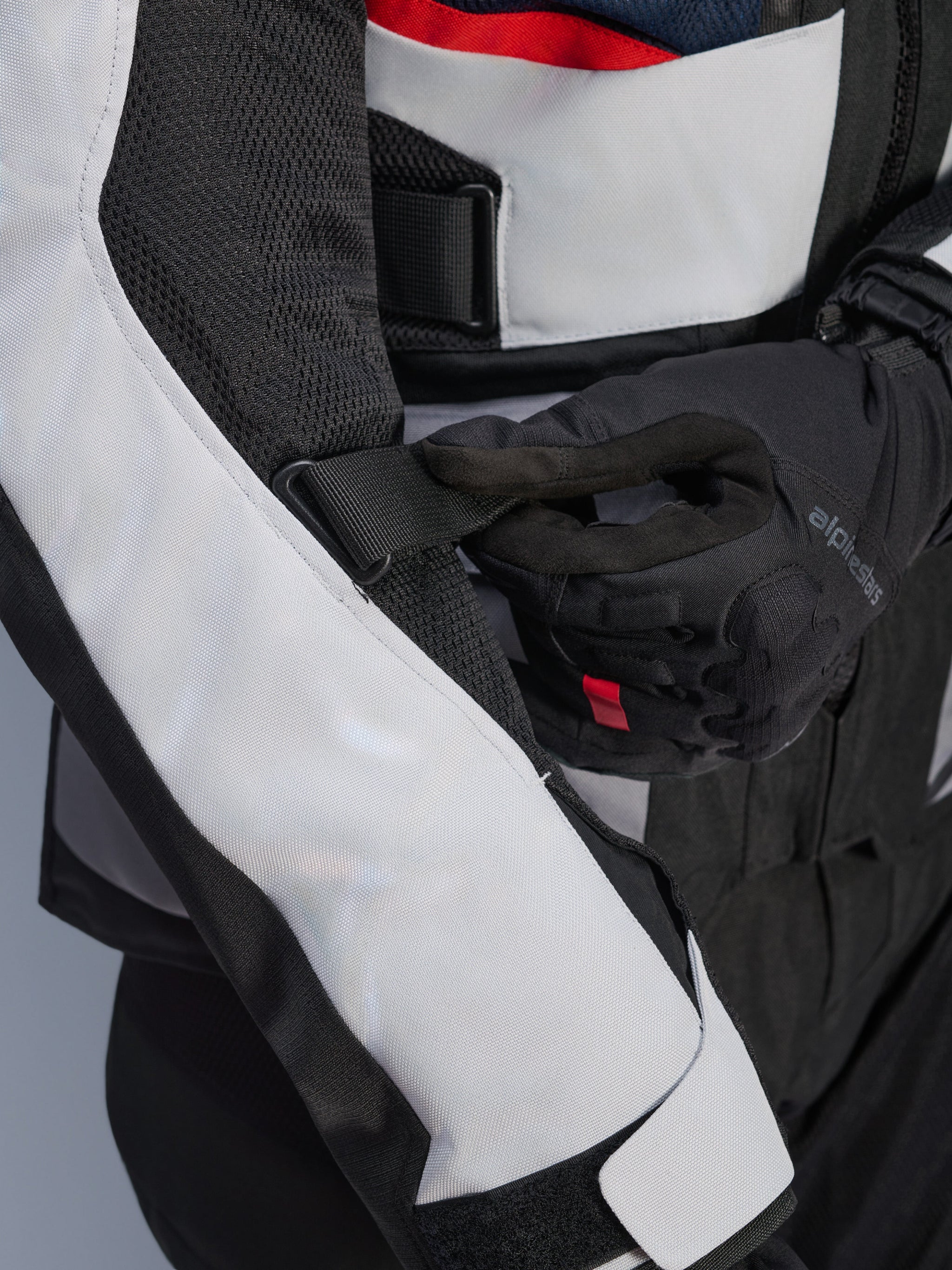 Alpinestars Andes Air Drystar® Jacket in Deep Blue Black Ice Gray, close-up view of the adjustable sleeve strap and mesh ventilation panels, featuring durable textile construction for adventure touring