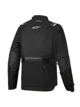 Alpinestars Woman Stella Andes V4 Drystar® Jacket, Black, back view, featuring a large rear storage pocket, white Alpinestars logo on upper back and text branding on lower back, adjustable waist and arm straps, durable textile adventure touring jacket