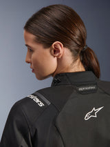 Alpinestars Woman Stella Andes V4 Drystar® Jacket, Black, close-up view of the upper back and shoulder, featuring white embroidered Astar logo and branding, technical textile construction for motorcycle adventure riding