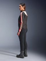Alpinestars Stella T-Dyno WR Jacket, Women's textile motorcycle jacket, Black Ecru and Bright Red, featuring vintage-inspired design with Astars branding on the sleeve, worn with slim black pants and black boots, shorter biker fit for urban road riding