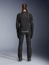 Alpinestars Stella ST-2 Air Jacket, Women's Motorcycle Jacket, Black, rear view featuring red logo on upper back and grey branding on lower back, worn with matching black riding pants and boots, modern touring design with mesh panels and reflective details