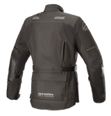 Alpinestars Women Stella Andes V3 Drystar® Jacket, Black and Dark Gray, rear view featuring waterproof textile construction, large utility pocket on the lower back, adjustable waist strap, and reflective safety accents.