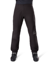 Alpinestars AMT-8 Stretch Drystar® XF Pant Liner, Black, front view worn with black motorcycle boots, featuring grey star logo and AMT branding on the leg, versatile waterproof and windproof motorcycle apparel
