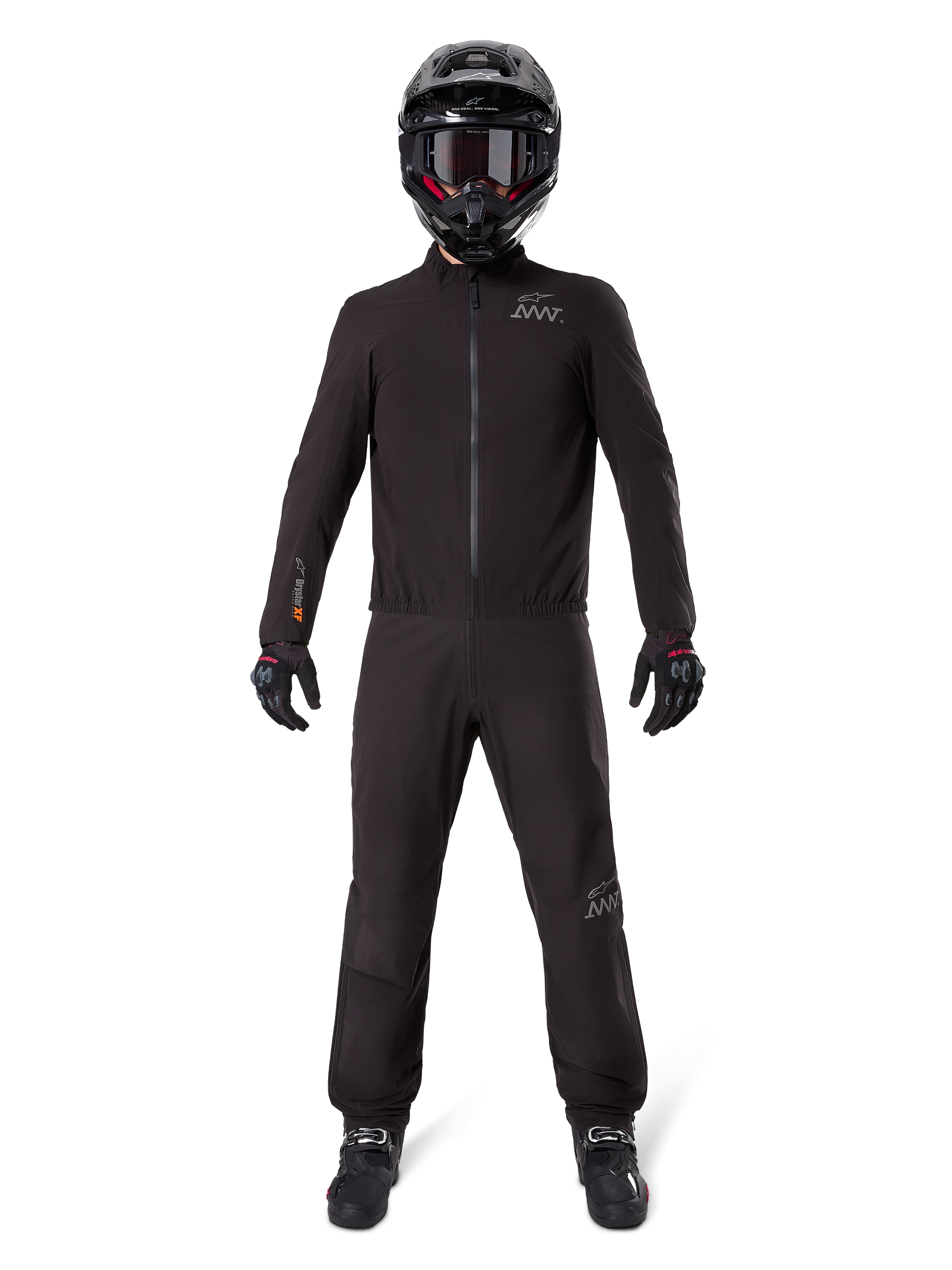 Motorcycle rider wearing Alpinestars AMT-8 Stretch Drystar® XF Pant Liner and matching jacket, all-black waterproof and windproof technical gear, featuring a black helmet, gloves, and boots, sleek adventure touring design.