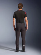 Alpinestars Aeroshell Pants, crossover sports softshell motorcycle pants, Black, rear view worn with a black short-sleeve base layer, featuring a slim fit, pre-curved knees, and white Astars logo on the lower left leg.