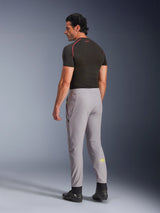 Alpinestars Aeroshell Pants, Mid Gray Yellow Fluo, back-side view of male model wearing stretch softshell motorcycle pants, features yellow Astars logo on the left calf, paired with a black base layer and riding shoes for a modern sports silhouette.