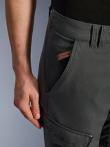 Alpinestars Borrego Drystar® Pants, Adventure Motorcycle Pants, Anthracite Gray, close-up detail of the pocket and hip, waxed-canvas texture with a brown leather logo tag and embroidered Alpinestars branding on the thigh cargo pocket.