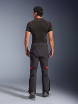 Alpinestars Halo Pro Drystar® XF Laminated Pants, Adventure Motorcycle Pants, Black Dark Shadow with red highlights, rear view worn with a black short-sleeve base layer and black adventure boots, showcasing a durable 3-layer laminated construction and ergonomic fit.