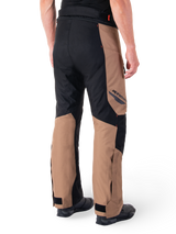 Alpinestars St-1 Waterproof Pants, Motorcycle Touring Pants, Dark Khaki Sand and Black with Red Fluo accents, rear three-quarter view, featuring Alpinestars branding on the thigh and adjustable ankle straps, worn with black boots.