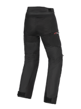 Alpinestars Andes V4 Drystar® Pants, Adventure Motorcycle Pants, Black, rear view showing textile construction with reinforced seat and knee areas, red Drystar logo on the hip, adjustable waist and ankle straps, waterproof and durable design for all-weather riding