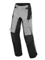 Alpinestars Andes V4 Drystar® Pants, Adventure Motorcycle Pants, Black and Dark Gray, featuring reinforced black knee and shin panels, zippered thigh vents, and cargo pockets, with a white Alpinestars logo on the hip, designed for all-weather road and adventure riding.