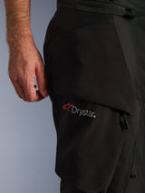 Alpinestars Andes V4 Drystar® Pants, Black, close-up of the thigh area showing the Drystar® logo on a cargo pocket, technical textile material with reinforced panels, waterproof adventure motorcycle riding pants