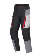 Alpinestars Honda ST-1 Waterproof Pants, Motorcycle Touring Pants, Ice Gray, Dark Gray and Black with Red Accents, technical textile construction with waterproof liner, zippered cargo pockets, and ergonomic pre-curved legs