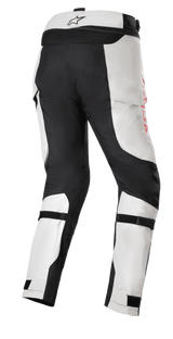 Honda Bogota' Pro Drystar® Pants, Adventure Touring Motorcycle Pants, Ice Gray and Black, rear view featuring reinforced black panels on the seat and inner legs, red side branding, and adjustable calf straps for a secure fit.