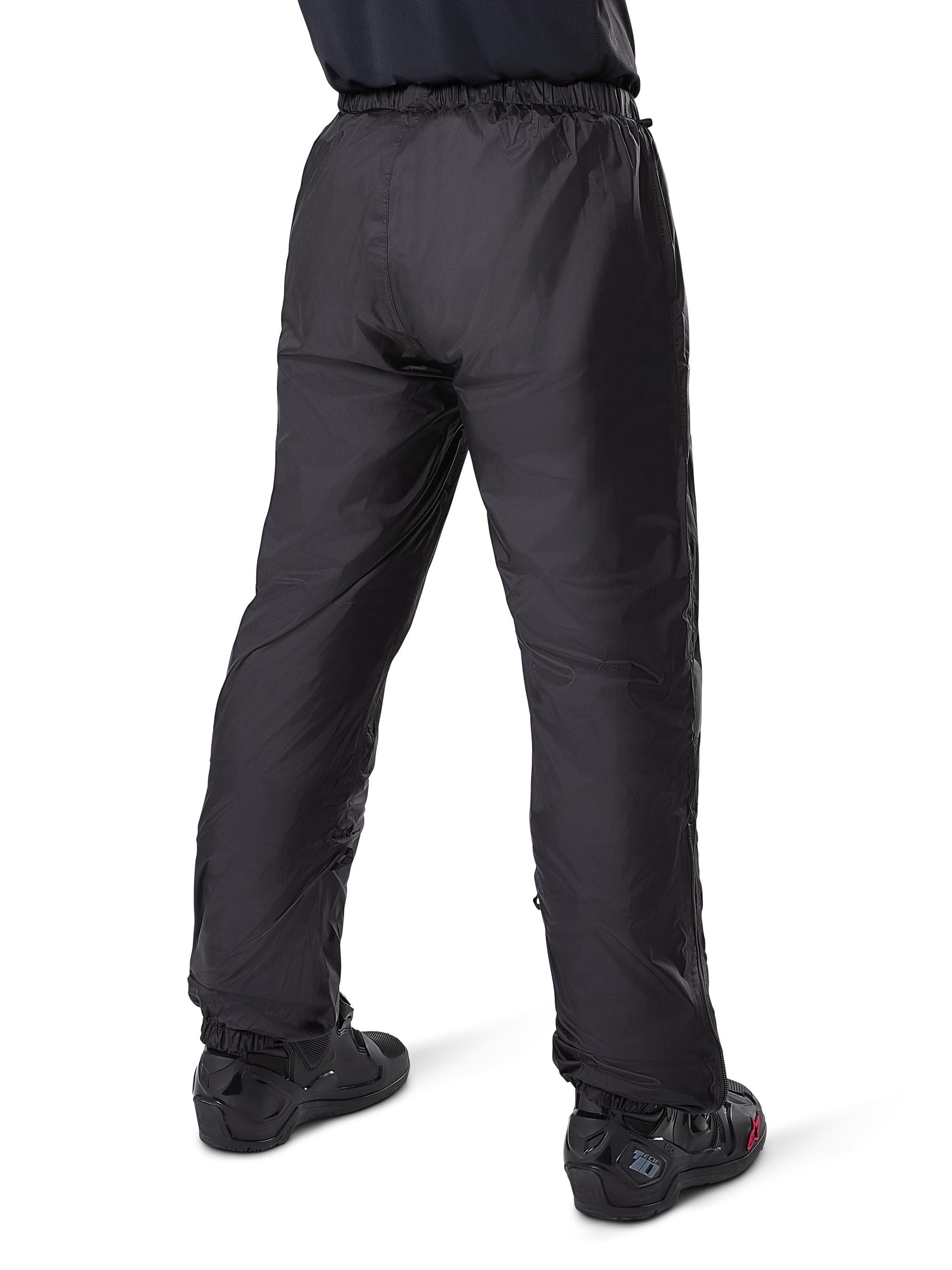 Alpinestars Bogota' Pro Drystar® 3 Seasons Pants, Black adventure touring motorcycle pants, rear view of the waterproof Drystar® liner worn as over-pants, paired with black motorcycle boots, technical lightweight construction for multi-season weather protection
