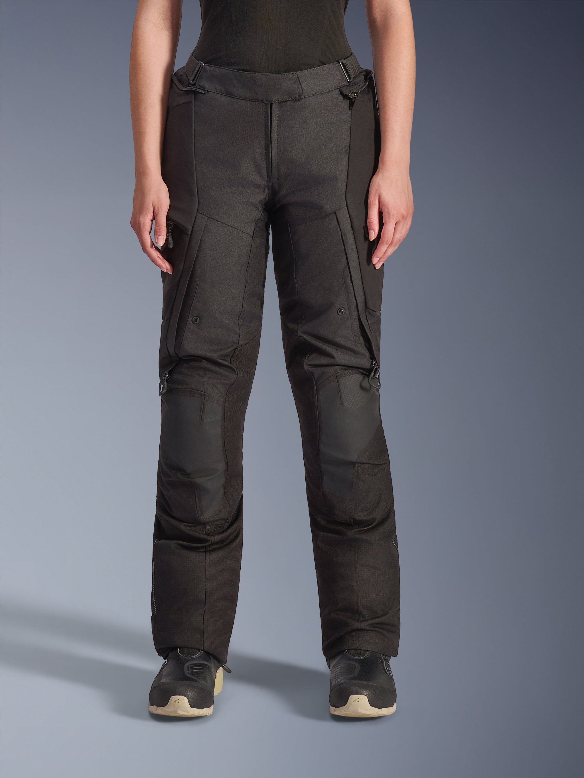 Alpinestars Stella Andes V4 Drystar Pants, Women's Adventure Touring Pants, Black, front view, featuring reinforced knee panels, water-resistant cargo pockets, and adjustable waist straps, worn with black boots in a studio setting.