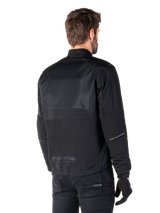 Alpinestars Mootant Waterproof Parka, Black motorcycle jacket, rear view, featuring mesh upper panels and MO.ST.EQ. Moto Streetwear Equipment branding, urban contemporary design for road riding