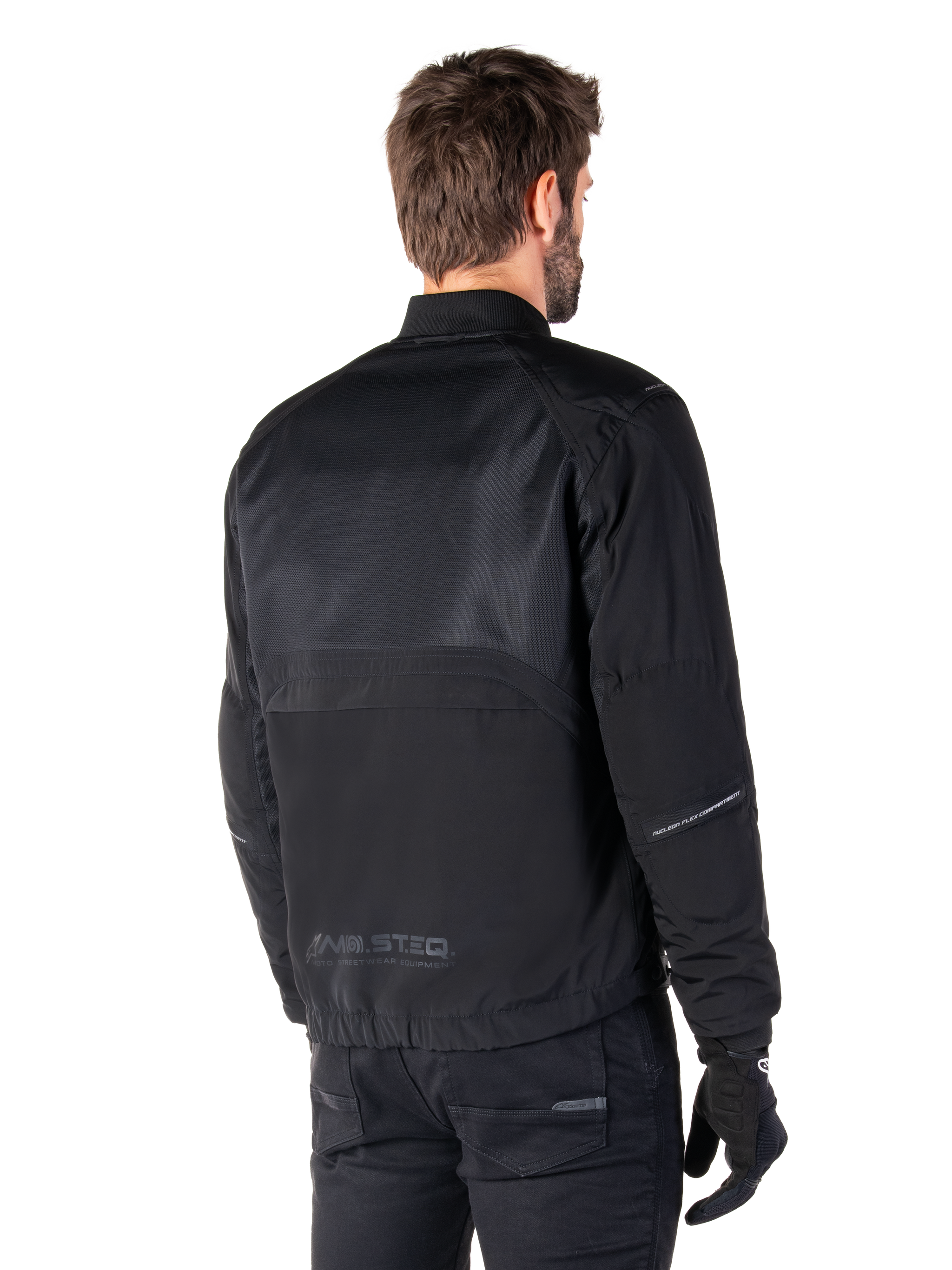 Alpinestars Mootant Waterproof Parka, Black motorcycle jacket, rear view, featuring mesh upper panels and MO.ST.EQ. Moto Streetwear Equipment branding, urban contemporary design for road riding