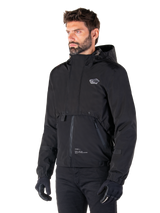 Alpinestars Mootant Waterproof Parka, Black modular motorcycle jacket, worn by a man with black gloves and pants, features a hood, front zipper, and layered utilitarian design, sleek urban aesthetic with logo on chest.