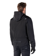 Alpinestars Mootant Waterproof Parka, Black Motorcycle Jacket, Rear view showing hooded design, white logo on shoulder and MO.ST.EQ. reflective branding on lower back, urban contemporary riding gear