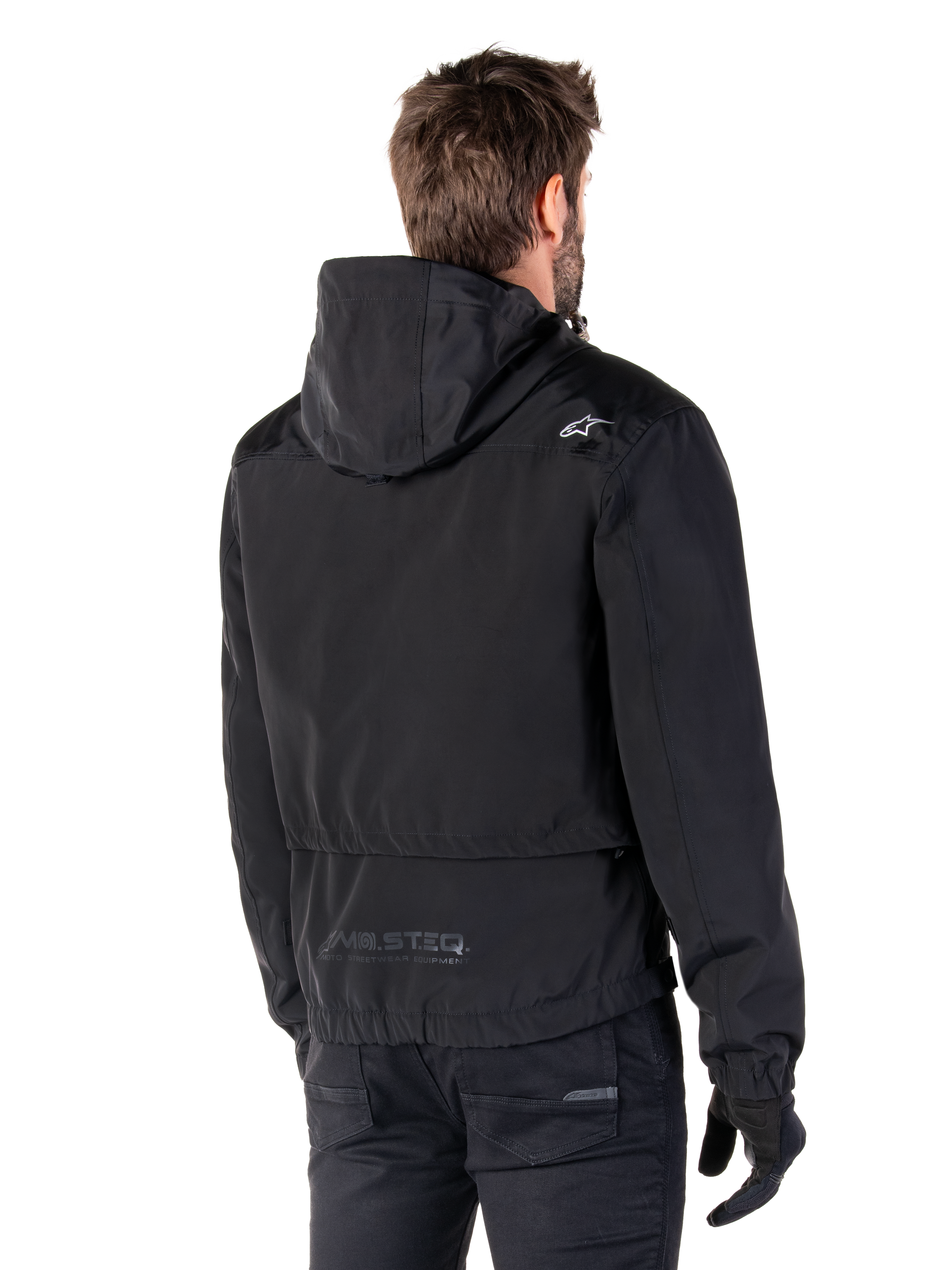 Alpinestars Mootant Waterproof Parka, Black Motorcycle Jacket, Rear view showing hooded design, white logo on shoulder and MO.ST.EQ. reflective branding on lower back, urban contemporary riding gear