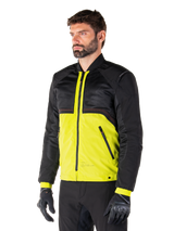 Alpinestars Mootant Waterproof Parka in Lime Punch Black, modular motorcycle jacket with a black mesh upper and vibrant lime green lower body, worn by a male rider with black gloves and pants, urban contemporary riding style.