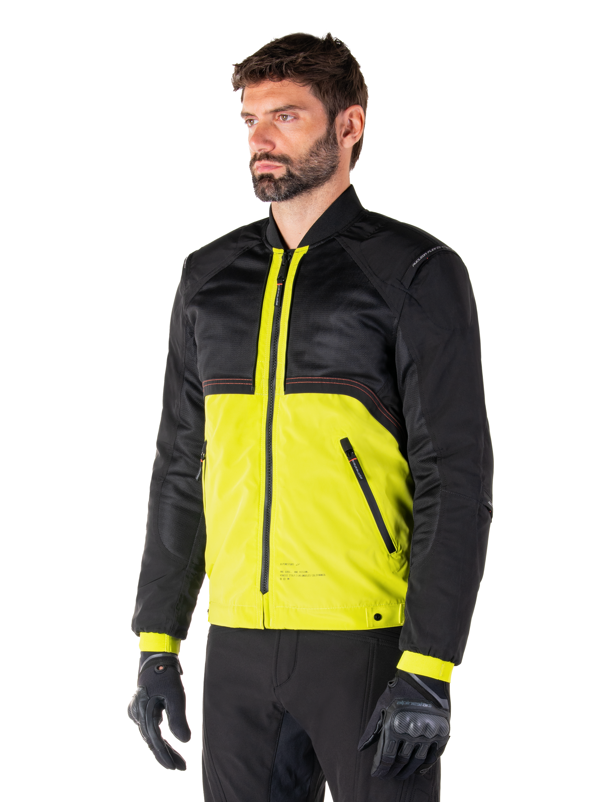Alpinestars Mootant Waterproof Parka in Lime Punch Black, modular motorcycle jacket with a black mesh upper and vibrant lime green lower body, worn by a male rider with black gloves and pants, urban contemporary riding style.