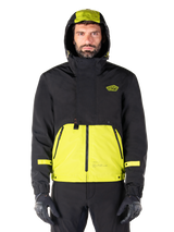 Alpinestars Mootant Waterproof Parka, Lime Punch Black motorcycle jacket, front view, modular 3-in-1 design with black upper and bright lime green lower section, featuring a drawstring hood and chest logo, worn with black pants and riding gloves