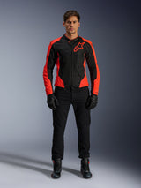 Male model wearing the Alpinestars Viper Air V4 Jacket in Red Fluo and Black, paired with black riding pants, gloves, and boots, featuring breathable mesh panels for ventilation and a bold star logo on the chest, sporty motorcycle road apparel