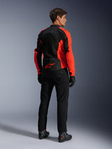 Alpinestars Viper Air V4 Jacket, Red Fluo Black, rear view on model, featuring technical mesh panels and a red star logo on the lower back, paired with black motorcycle pants and gloves for a complete road riding look.