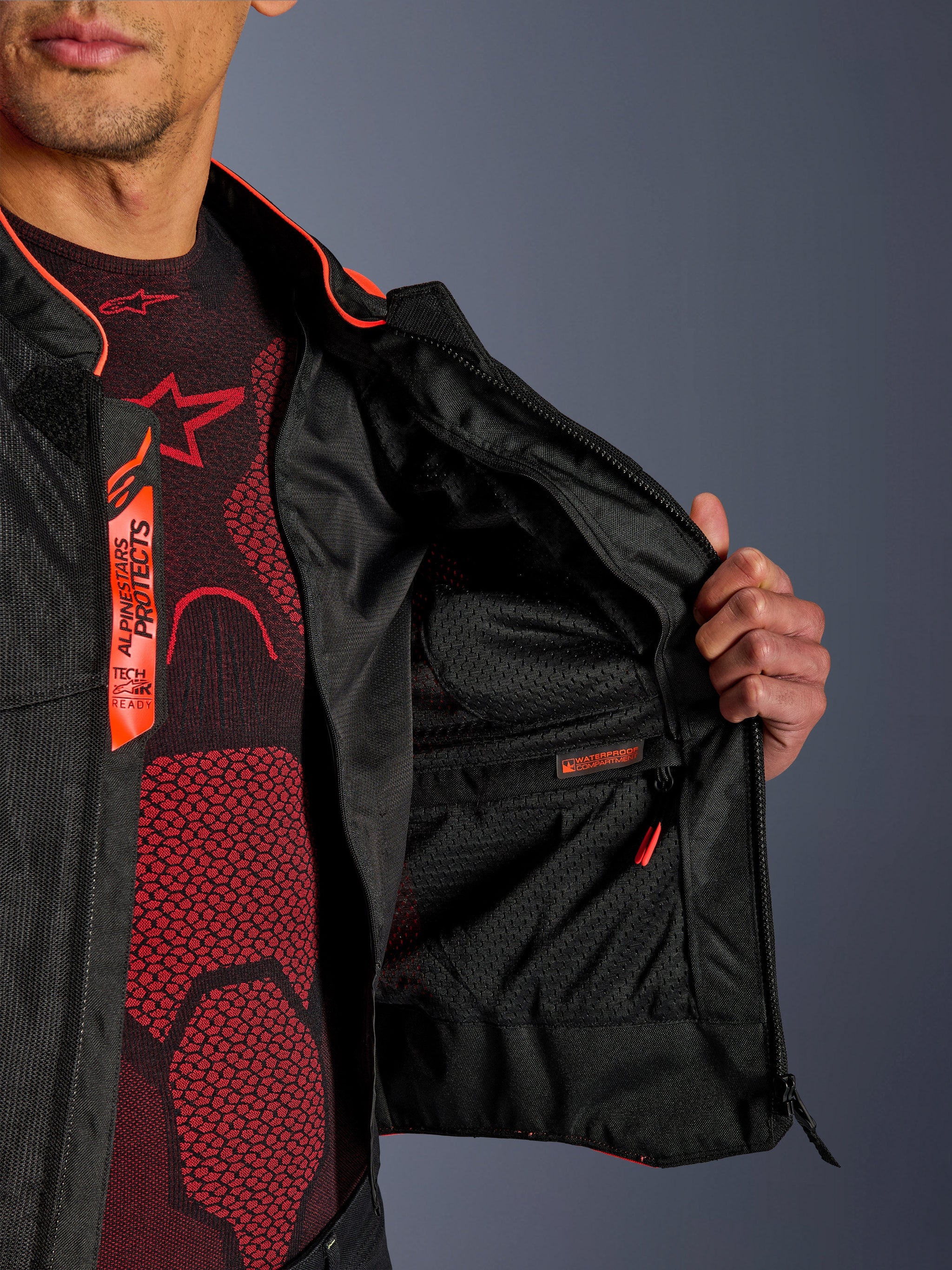 Alpinestars Viper Air V4 Jacket interior detail, showing the waterproof inner compartment and breathable tech mesh lining, Red Fluo and Black accents with Tech-Air Ready branding