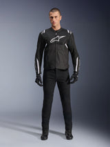 Alpinestars T-Sps Air V2 Jacket, Black and White textile motorcycle jacket, featuring large white chest logo and mesh paneling, worn by a model with black gear for urban sport riding