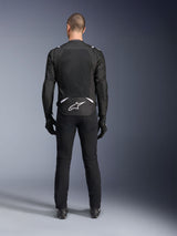 Alpinestars T-Sps Air V2 Jacket, Rear View, Black and White textile motorcycle jacket, featuring a large mesh back panel for maximum airflow and white Astars logo on the lower back, worn with black riding pants and gloves