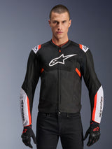 Alpinestars T-Sps Air V2 Jacket, Black with White and Red Fluo accents, motorcycle sport jacket, man wearing a mesh-vented design with large chest logo and branded sleeves, paired with black gloves and pants