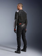 Alpinestars T-Sps Air V2 Jacket, Textile Motorcycle Jacket, Black White and Red Fluo, rear view on model, mesh paneling for ventilation, white Astars logo on lower back, styled with black riding pants and gloves