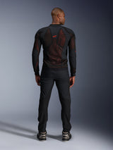 Alpinestars Troop-Air Pro Jacket in Black Red Fluo, rear view on model, technical armored mesh jacket with breathable panels, red logo on upper back, worn with black pants and sneakers, urban motorcycle apparel