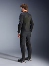 Alpinestars Troop-Air Jacket in Black and Yellow Fluo, rear view of a male model wearing the technical air jacket, featuring a large mesh back panel with yellow highlights and fluo yellow Alpinestars logos, paired with black motorcycle pants.