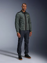 Alpinestars Ignite Air Jacket, Urban Gray Black Blue, urban motorcycle jacket, worn by a model with dark denim jeans and black sneakers, featuring a mesh body, traditional shirt collar, Harrington-inspired silhouette, and gold Alpinestars branding.