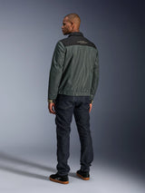 Alpinestars Ignite Air Jacket in Urban Gray Black Blue, rear view on model, featuring a mesh body with a black shoulder yoke and white text, striped cuffs, paired with dark denim jeans and black sneakers, urban lifestyle motorcycle apparel